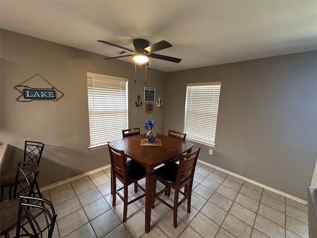 tiled dining area with ceiling fan