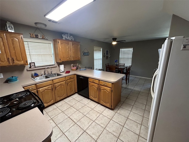 kitchen with sink, light tile patterned floors, kitchen peninsula, ceiling fan, and black appliances