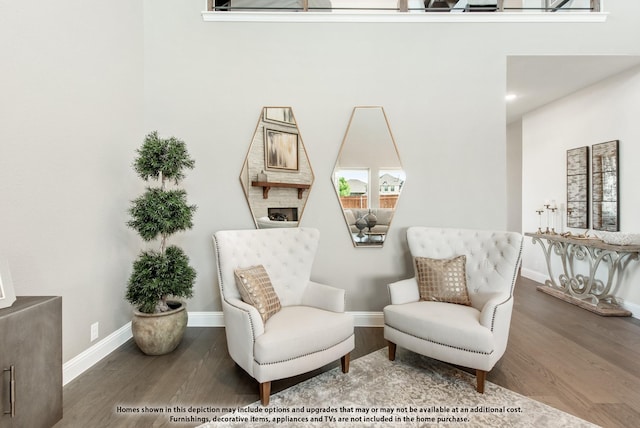 sitting room with hardwood / wood-style flooring