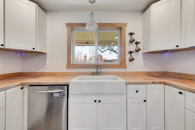 kitchen with wood counters, white cabinets, sink, decorative light fixtures, and dishwasher