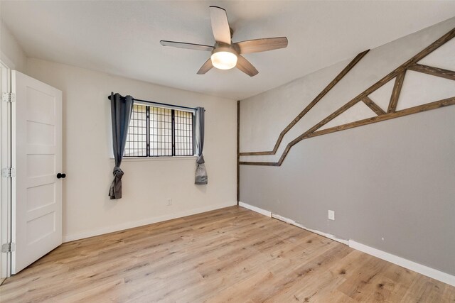 unfurnished room with ceiling fan and light wood-type flooring