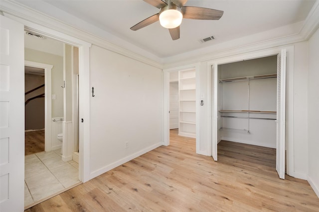 unfurnished bedroom with connected bathroom, light hardwood / wood-style floors, and ceiling fan