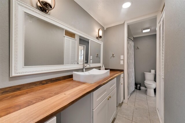 bathroom with vanity, tile patterned floors, a shower with curtain, crown molding, and toilet