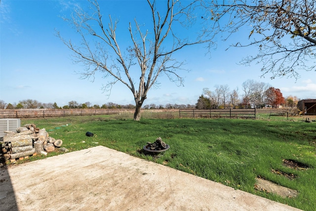 view of yard with cooling unit, a patio, and a rural view