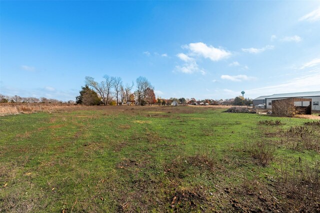 view of yard with a rural view