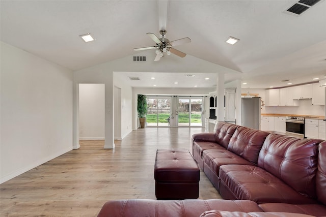 living room featuring french doors, ceiling fan, beam ceiling, high vaulted ceiling, and light hardwood / wood-style floors