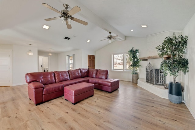 living room with vaulted ceiling with beams, ceiling fan, and light hardwood / wood-style flooring