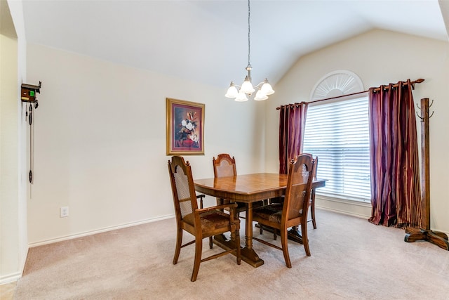 carpeted dining room featuring a chandelier and lofted ceiling