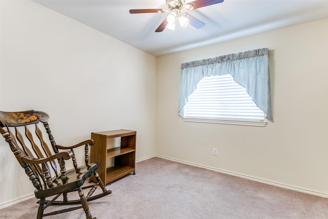 living area featuring ceiling fan and light colored carpet