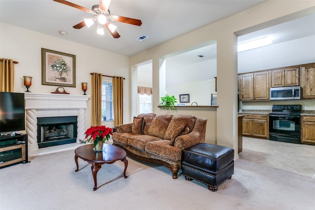 living room featuring ceiling fan and light carpet