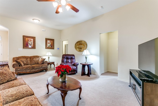 living room with ceiling fan and light colored carpet