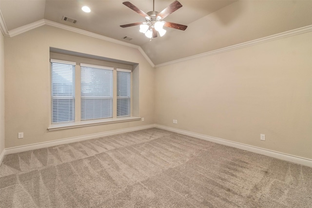 empty room featuring crown molding, carpet, and vaulted ceiling