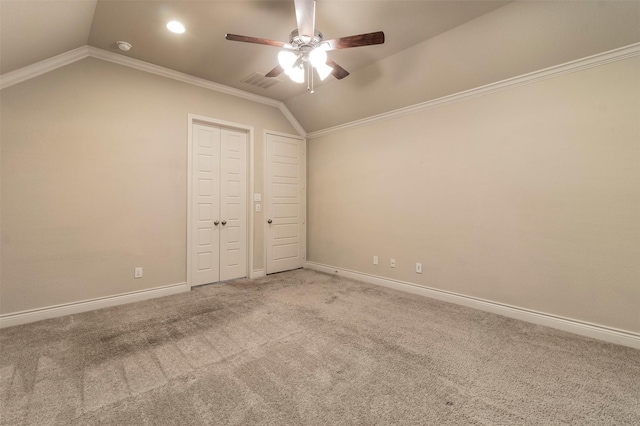 unfurnished bedroom featuring carpet floors, crown molding, ceiling fan, and lofted ceiling