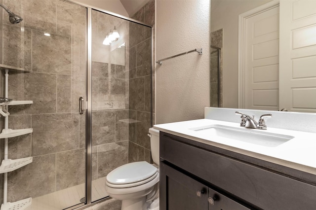 bathroom featuring vanity, toilet, and walk in shower