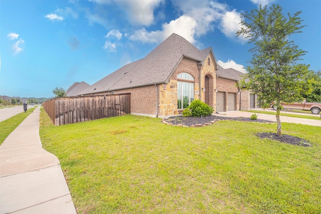 view of side of home featuring a lawn and a garage