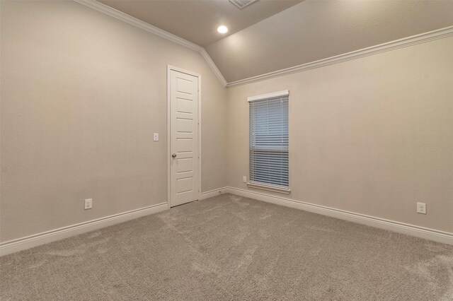 carpeted empty room with lofted ceiling and ornamental molding