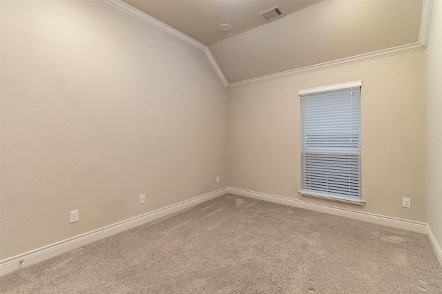 spare room with carpet flooring, vaulted ceiling, and ornamental molding