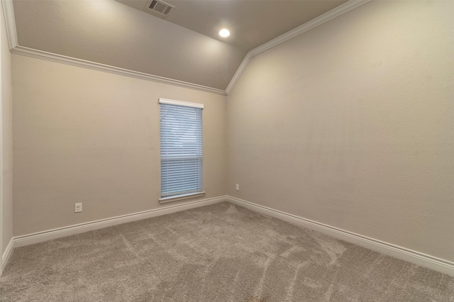 spare room with carpet, crown molding, and lofted ceiling