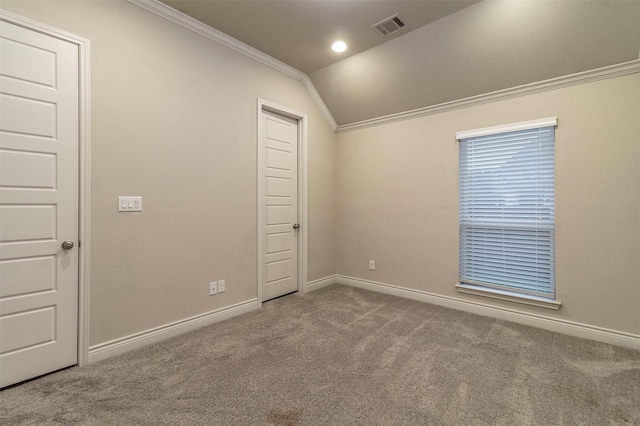 carpeted spare room with vaulted ceiling and ornamental molding