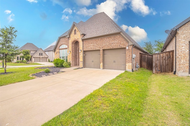 view of front of house with a garage and a front lawn