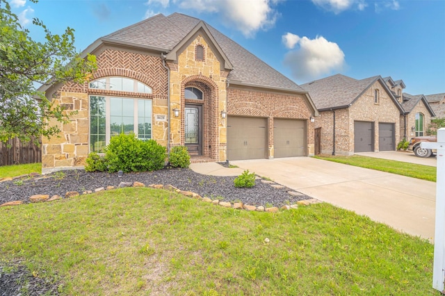 french provincial home featuring a garage and a front yard