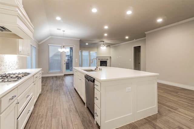 kitchen featuring lofted ceiling, a kitchen island with sink, sink, appliances with stainless steel finishes, and white cabinetry