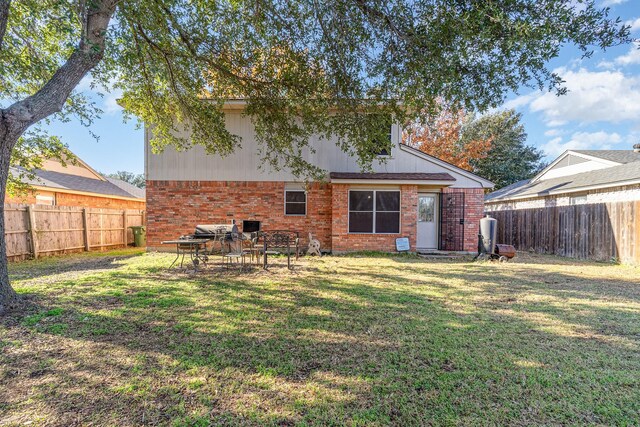 rear view of property with a yard