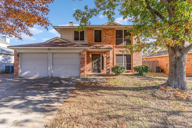 view of front of property with central AC unit and a garage