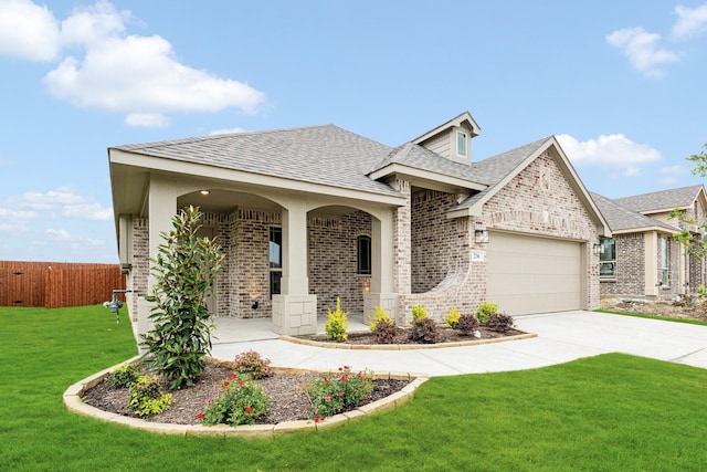 view of front of home with a garage, fence, roof with shingles, and brick siding
