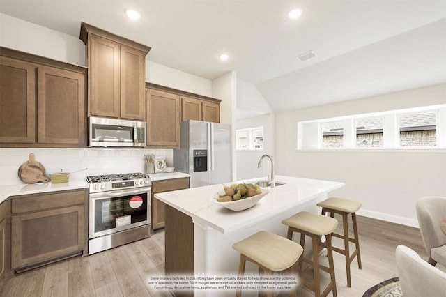 236 Cheyenne Trl, Alvarado, TX 76009 - kitchen featuring appliances with stainless steel finishes, a sink, light countertops, light wood-type flooring, and recessed lighting