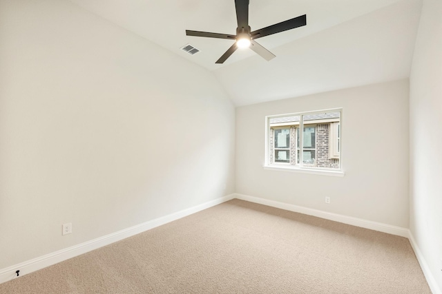 spare room with a ceiling fan, baseboards, visible vents, and light carpet
