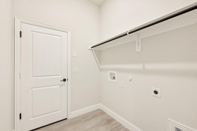 clothes washing area featuring washer hookup, gas dryer hookup, laundry area, electric dryer hookup, and baseboards