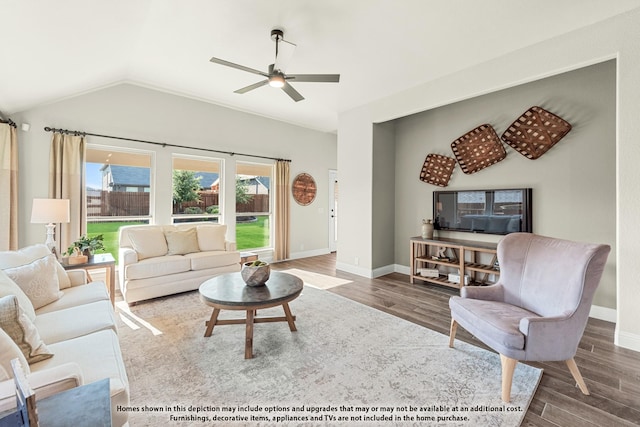 living room featuring hardwood / wood-style floors, vaulted ceiling, and ceiling fan