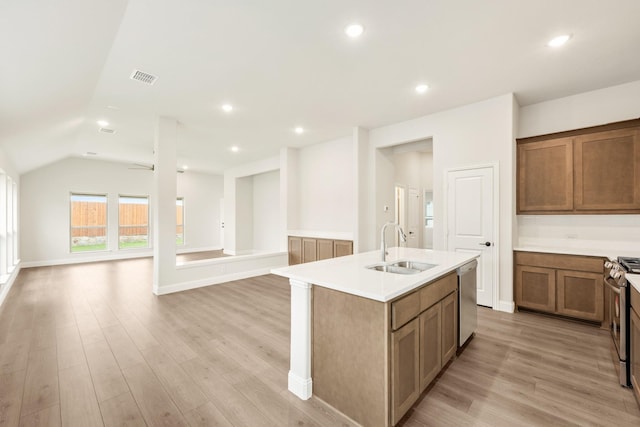 kitchen featuring visible vents, light wood-style floors, open floor plan, a sink, and appliances with stainless steel finishes