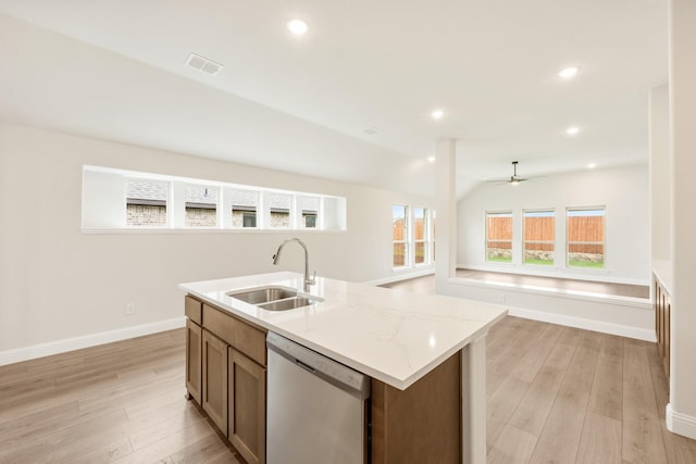 kitchen featuring a sink, dishwasher, open floor plan, light wood-type flooring, and visible vents