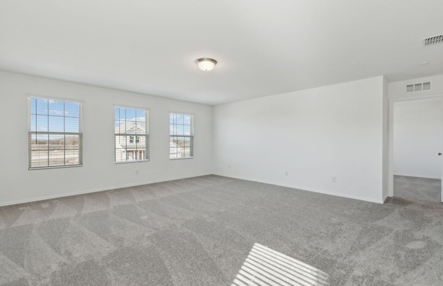 unfurnished room with light carpet