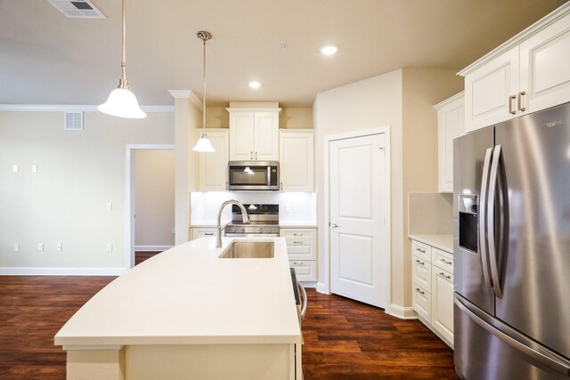 kitchen with white cabinetry, stainless steel appliances, dark hardwood / wood-style floors, an island with sink, and pendant lighting