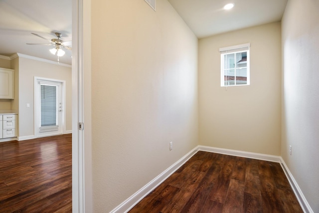 unfurnished room with dark hardwood / wood-style floors, ceiling fan, and ornamental molding