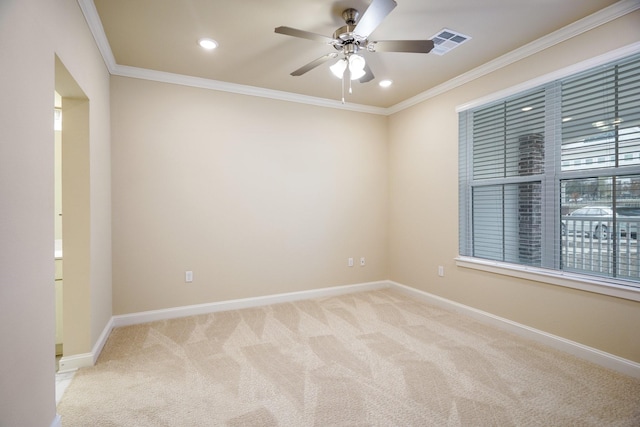 unfurnished room featuring crown molding, ceiling fan, and light carpet