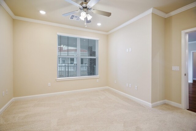 carpeted empty room with ceiling fan and ornamental molding