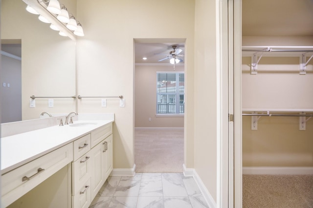 bathroom with crown molding, vanity, and ceiling fan