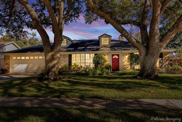 view of front facade featuring a garage and a yard