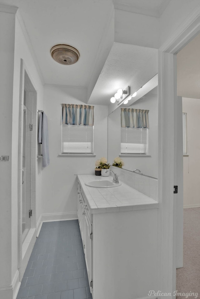 bathroom featuring a shower, vanity, and tile patterned floors