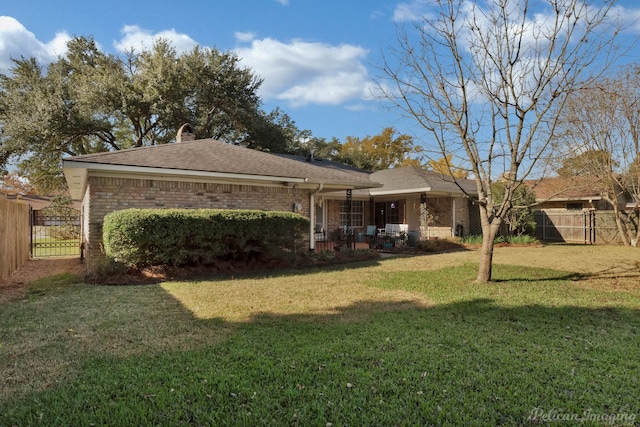 back of house with a yard