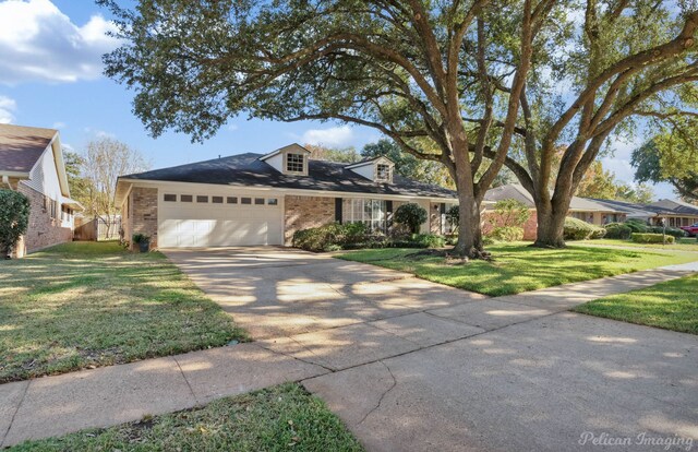 view of front of property featuring a garage and a front lawn