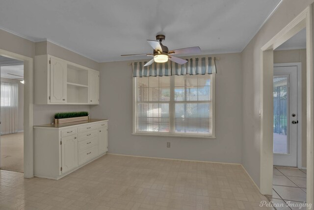 kitchen featuring light stone countertops, backsplash, white appliances, sink, and white cabinets