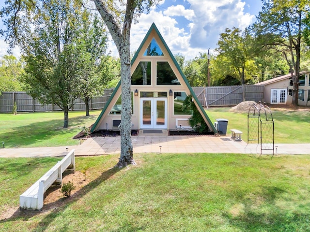 view of play area with french doors, a yard, and a patio area