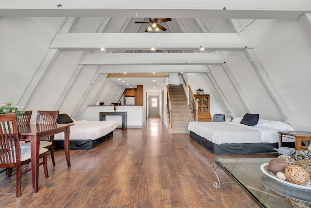 bedroom with vaulted ceiling with beams and dark hardwood / wood-style floors