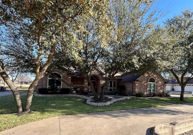 english style home featuring a front yard