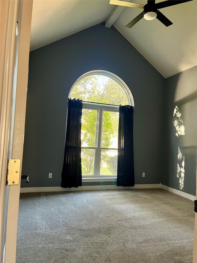 carpeted spare room featuring vaulted ceiling with beams and ceiling fan